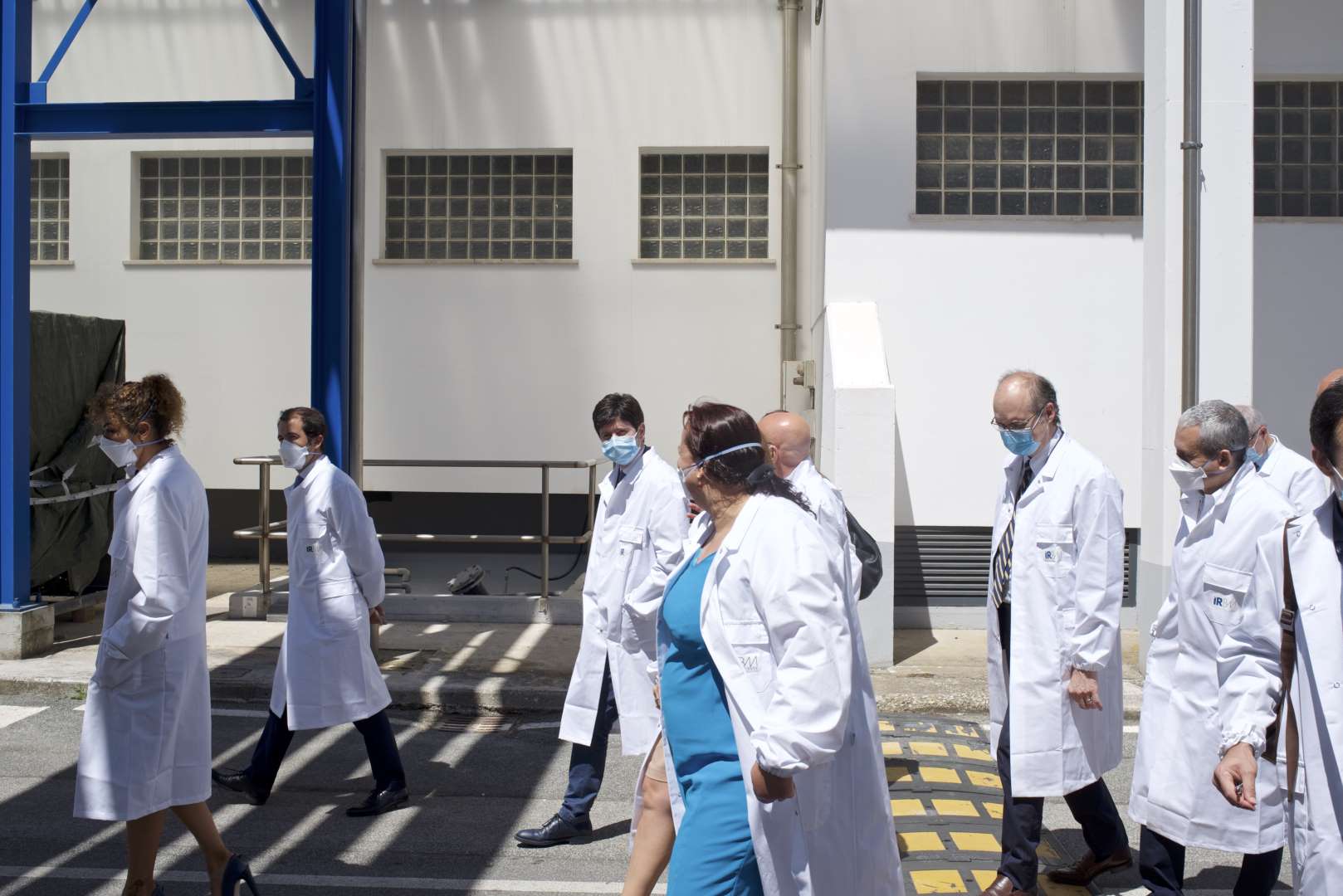 Roberto Speranza, Italian health minister, center facing camera, is taken on a tour of the labs at IRBM in Pomezia, Italy, on June 18, 2020. (Geraldine Hope Ghelli)