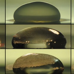 Images of a droplet on a surface show the process of freezing (top row), during which condensation temporarily forms on the outside of the droplet as it freezes. The next two rows show the droplet thawing out on a surface coated with the new layered material. In the middle row, the droplet is heated by the coating immediately upon freezing, and the dashed lines show where the freezing at top is just catching up with the thawing from below. The bottom row shows a slower thawing process. Under identical conditions, the droplet stays frozen without the new coating. (The Varanasi Research Group)