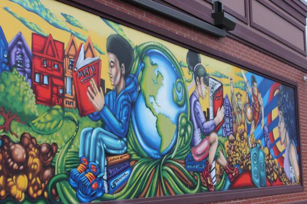 A group of Chicago South Side youths unveil this mural for a Garrett Popcorn Shop.