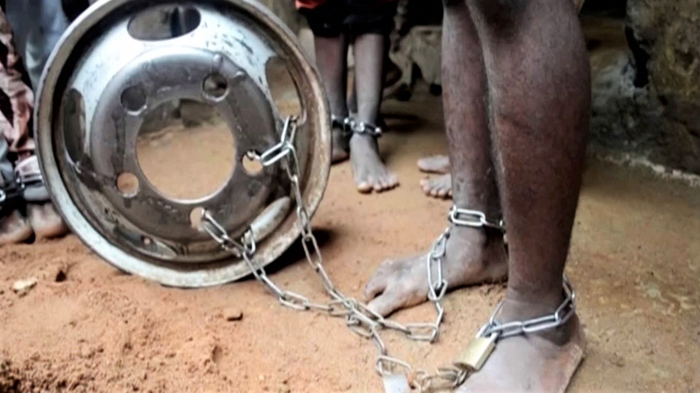 People are pictured with chained ankles and wrists. (Television Continental/via REUTERS)