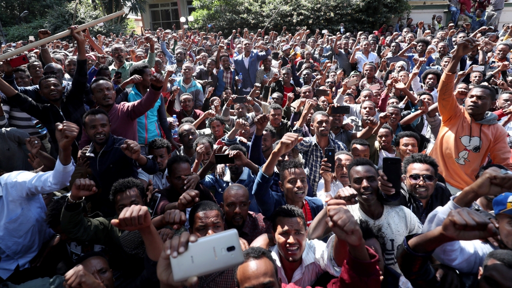 At least 400 young men joined the protest at Jawar's house in the capital Addis Ababa while some two dozen police officers stood nearby [Tiksa Negeri/Reuters]