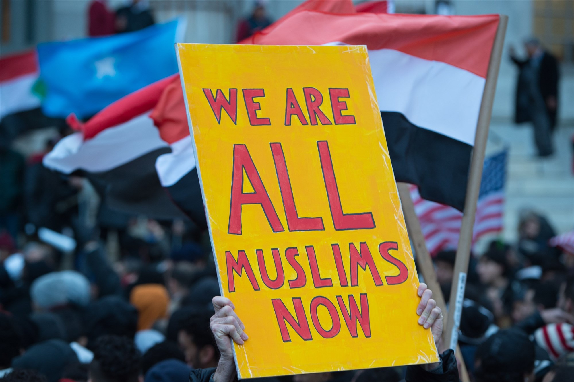 People rally at Brooklyn Borough Hall as Yemeni bodega and grocery-stores shut down to protest US President Donald Trump's Executive Order banning immigrants and refugees from seven Muslim-majority countries, including Yemen, on February 2, 2017 in New York. (Bryan R. Smith - AFP/Getty Images).
