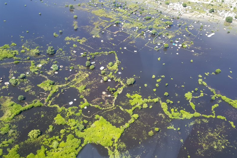 In this photo taken Sunday, Oct. 20, 2019 and released by Medecins Sans Frontieres, areas are submerged by floodwaters between Bor and Pibor, seen from the air, in South Sudan. South Sudan's president on Tuesday, Oct. 29, 2019 declared a state of emergency in 27 counties because of the flooding and parts of the East African region are bracing for a tropical storm that could worsen an already dire humanitarian situation. (Medecins Sans Frontieres via AP)