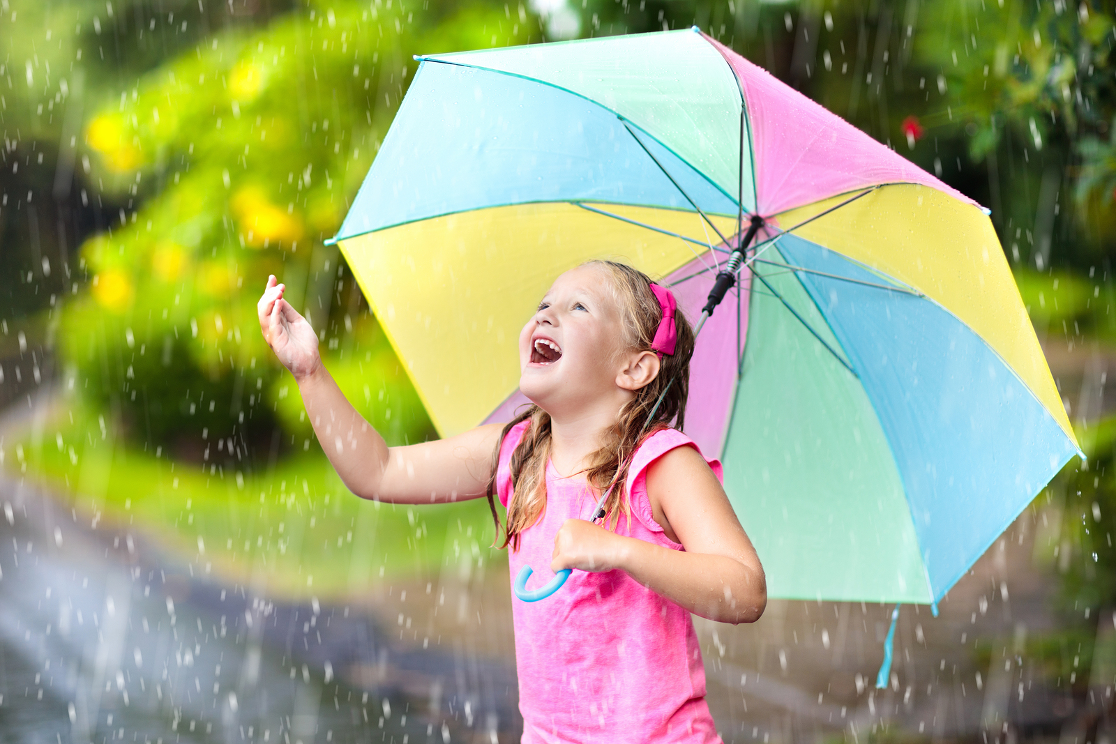 Kid With Umbrella Playing In Summer Rain.