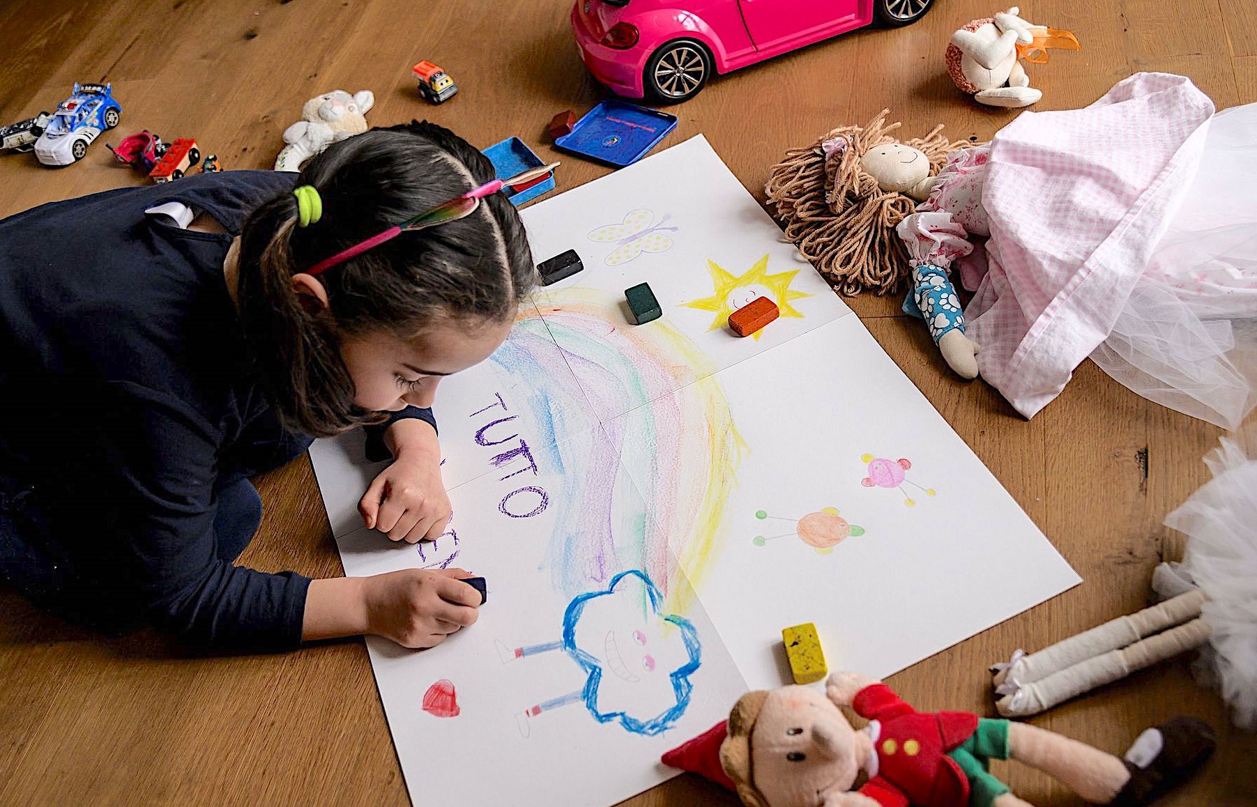 A girls makes a drawing reading "Everything is going to be alright", as part of school homework on the COVID-19 coronavirus on March 12, 2020 in Manta, near Cuneo, Northwestern Italy. (Images Marco Bertorello/AFP/GETTY Images)