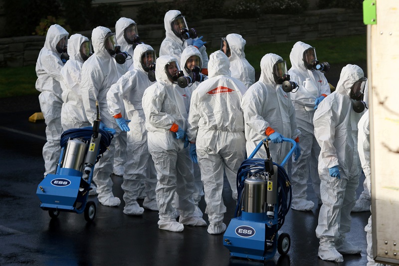 Members of a Servpro cleanup crew wearing hazardous material suits prepare to enter Life Care Center of Kirkland, the Seattle-area nursing home at the epicenter of one of the biggest coronavirus outbreaks in the United States. (Image, Reuters)
