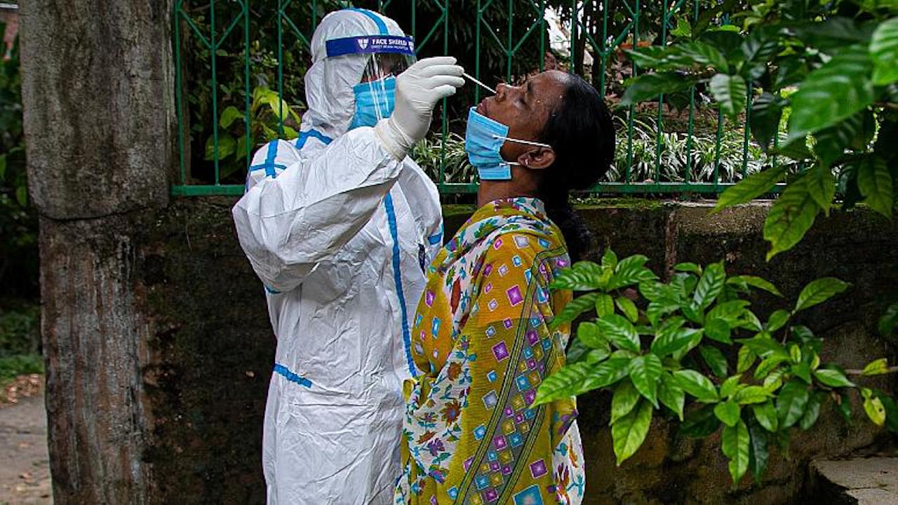 An Indian health worker takes a nasal swab sample to test for COVID-19 during a door to door test drive in Gauhati, India, Saturday, Aug. 29, 2020. (Image by AP Photo/Anupam Nath)