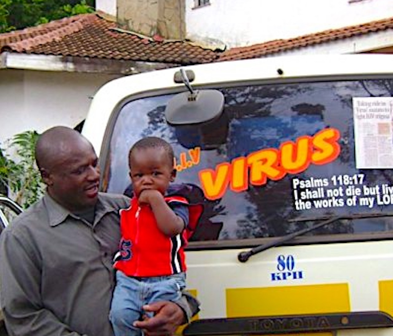 A FORUM member “living positively with AIDS,” pictured with his son. He uses his matatu (taxi) to send messages to the community about positive living and preventing HIV/AIDS.