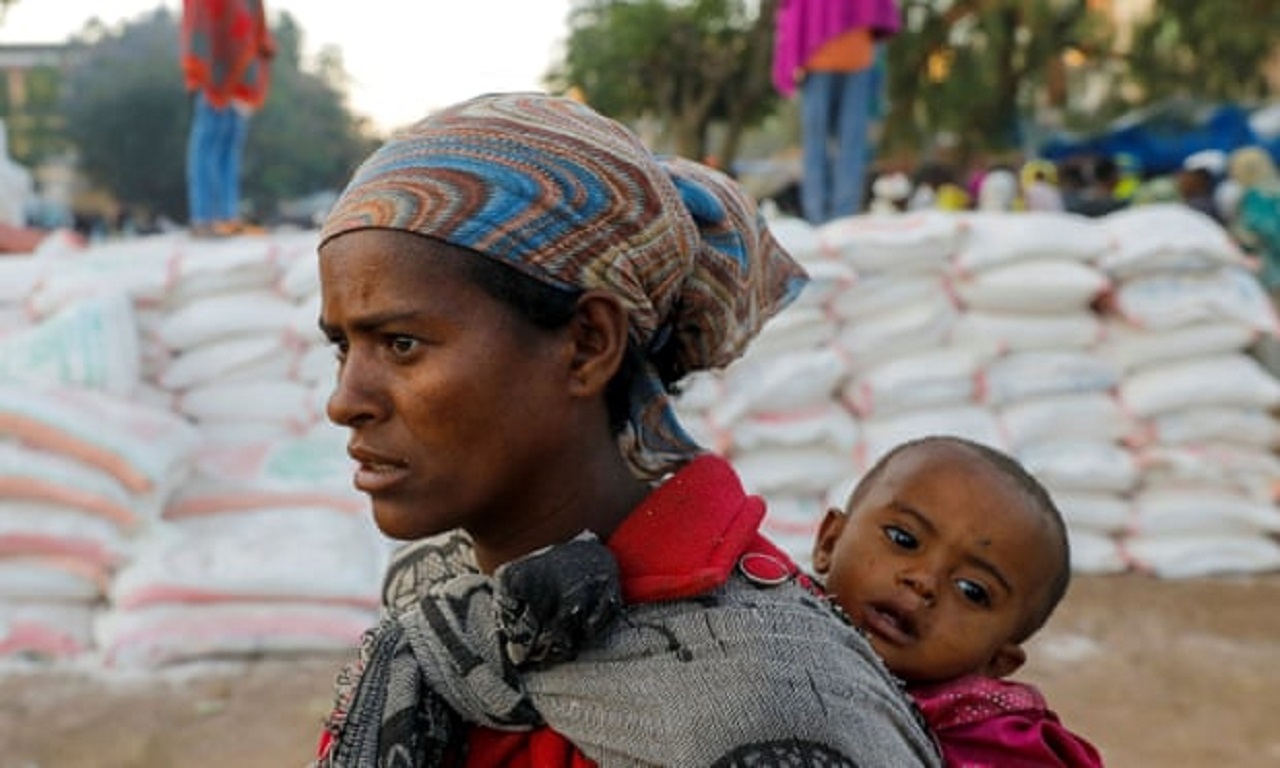 A mother and child queue for food in the Tigray region, Ethiopia. (Photograph by Baz Ratner/Reuters)